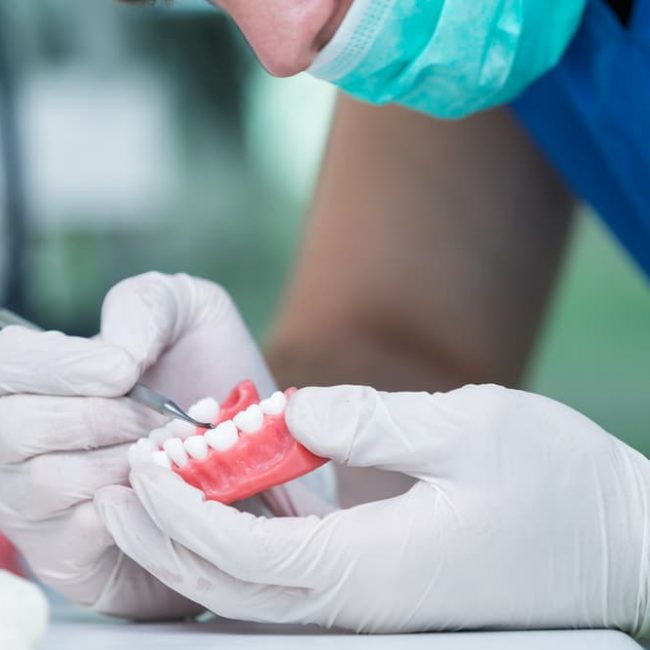 Dentist Repairing Denture — Denture Clinic in Bendigo, VIC
